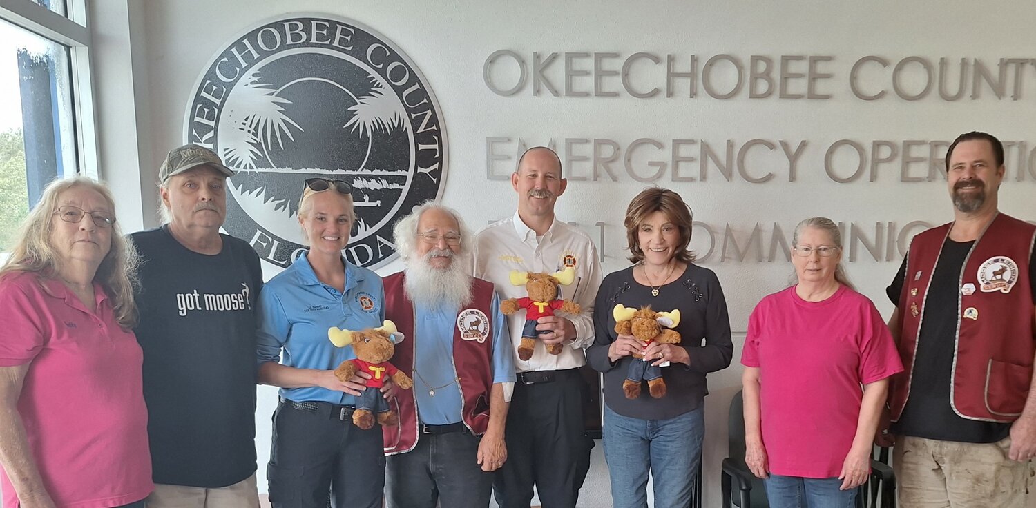 Okeechobee County Fire Rescue received a donation of Tommy Moose stuffed animals from the Okeechobee Moose Lodge 1753 and Chapter 956. In the photo shown (from left to right) is Patty Myall, Jeff Myall, Deputy Fire Marshal Jessica Sasser, Harry Marks (aka Santa), Fire Marshal Keith Bourgault, Maryann Newcomer, Bonnie Marks, and Jeff Pummell. Additionally, they informed us of their Christmas Event for children 12 and under on December 3rd from 1-3PM.